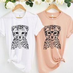 "This listing is for 1 shirt only. Any other items in the photo, such as shoes, pants, flowers etc., are NOT included. Cheetah tshirt, Hipster Animal Shirt, Gift for her, Gift for Animal Lovers, Birthday gift, Animal Gifts *This listing is for ONE t-shirt only. 1. ADULT UNISEX T-SHIRT - This t-shirt feels soft and light. It's comfortable and the unisex cut is flattering for both men and women. - Unisex T-shirt - Short Sleeve Jersey - Sideseamed. Fabrication: - Solid Colors: 100% combed and ring- Trendy Cotton T-shirt In Leopard Print, Trendy Leopard Print Cotton Tops, Cotton Leopard Print T-shirt For Summer, Leopard Print Cotton T-shirt With Short Sleeves, Cotton T-shirt With Leopard And Graphic Print, Leopard Print Graphic Cotton T-shirt, Cotton T-shirt With Leopard Print And Crew Neck, Cotton Leopard Print T-shirt With Graphic, Cute Leopard Print Summer Tops