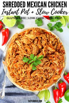 pulled pork with cilantro and lime on a white plate next to red peppers