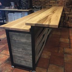 a kitchen island made out of wood and metal