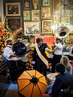 a group of people that are standing in front of a table with musical instruments on it