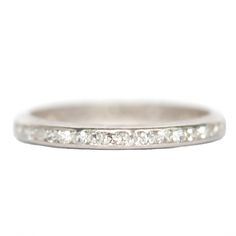 a white gold wedding band with five diamonds