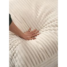 a person is holding onto a white mattress