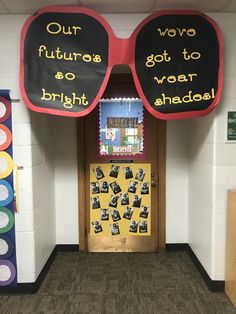 a classroom door decorated with posters and sunglasses