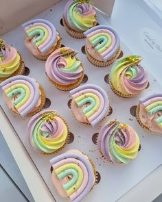 cupcakes with pastel frosting in a box