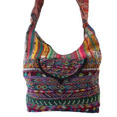 Huipil Hobo Bag handmade by Guatemalan artisans made from a repurposed "Huipil", a traditional Mayan blouse used by Guatemalan women. Fully lined with a zip top and one front pocket. perfect as travel bag, very roomy and lightweight.Details: 100% cotton textiles made entirely by hand in GuatemalaBlack lining Approximate size dimensions: 15.5"x15.5"Padded handle Up-cycled vintage embroidery in the front and backZipper ClosureFront pocket When buying up-cycle vintage clothing, many times you will Bohemian Multicolor Shoulder Bag For Trip, Multicolor Trip Bag With Pockets, Multicolor Travel Bag With Pockets, Multicolor Bohemian Bags For Trip, Traditional Hobo Shoulder Bag For Everyday Use, Bohemian Multicolor Bags With Pockets, Bohemian Shoulder Bag With Zipper Pocket For Travel, Traditional Handwoven Hobo Bag For Travel, Bohemian Multicolor Shoulder Bag With Zipper Pocket