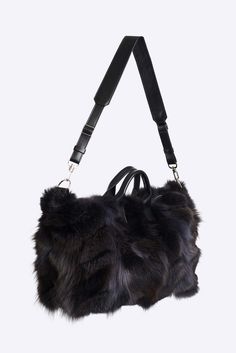 This medium duffle is made in soft upcycled fox pieces with leather trim, polyester lining and comes with a removable leather shoulder strap.Color and style of fur may vary slightly due to variations in the upcycling process. This item is made to order. Please allow 10 – 20 business days for International delivery. Luxury Shoulder Bag With Faux Fur Lining, Luxury Sheepskin Bags With Faux Fur Lining, Luxury Winter Shoulder Bag For Everyday Use, Luxury Shoulder Bag For Everyday Winter Use, Luxury Bags With Faux Fur Lining For Winter, Luxury Winter Travel Shoulder Bag, Luxury Travel Bags For Winter, Brown Sheepskin Bags For Winter, Luxury Sheepskin Bag For Everyday Use