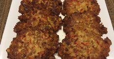 several crab cakes on a baking sheet ready to be cooked