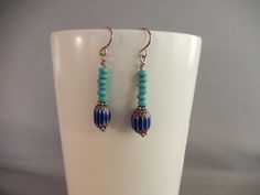 These earrings feature tiny wood beads in turquoise, plus a glass bead of dark blue, white and reddish brown in a chevron pattern. Hook style ear wire is silver-plated,nickel free and hypoallergenic. the earring are 1 and 1/2 inches long. Great for anyone who loves jewelry with a southwestern vibe. Southwestern Blue Beaded Earrings With Round Beads, Southwestern Style Blue Beaded Earrings, Bohemian Blue Beaded Hypoallergenic Earrings, Bohemian Blue Hypoallergenic Beaded Earrings, Southwestern Blue Earrings With Ear Wire, Blue Bohemian Beaded Sterling Silver Earrings, Bohemian Blue Beaded Sterling Silver Earrings, Nickel-free Blue Southwestern Earrings, White Gemstone Necklace