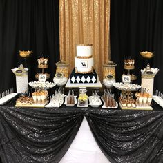 a black and white table topped with lots of desserts