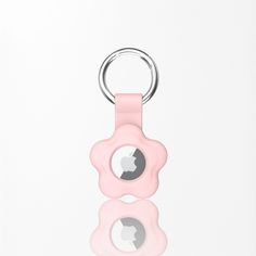 a pink pacifier keychain with an apple in the middle on a white background