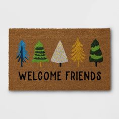 welcome friends door mat with trees on it