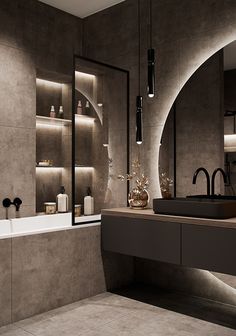 a bathroom with a sink, mirror and bathtub in the middle is lit by recessed lights