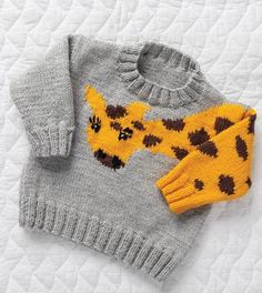 a knitted sweater with a giraffe on it