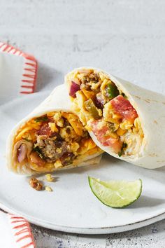 a burrito cut in half on a plate