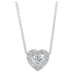 Enchanting 1.14ct Diamonds Halo Necklace in 18k White Gold - GIA Certified Experience the allure of love with this enchanting heart-shaped diamond necklace with a pendant, fashioned from premium 18K white gold. At its heart lies a captivating 1.01-carat diamond. Surrounding this exquisite diamond are 18 round diamonds totaling 0.13 carats, further accented by a very good cut to ensure vibrant sparkle from every angle. This is GIA certified, guaranteeing its authenticity and exceptional quality. Metal: 18k White Gold Main stone: 1 pc Diamond Main stone carat weight: 1.01ct Shape: Heart Color grade: E Clarity grade: VVS1 Side stone: 18 pcs Diamonds Side stone carat weight: 0.13ct Shape: Round Color grade: F Clarity grade: VS Cut grade: Very Good Total carat weight: 1.14ct Total jewelry weigh Dazzling White Gold Heart Cut Necklace, Formal White Gold Diamond Heart Cut Necklace, Platinum Heart Cut Jewelry With Halo Setting, Heart Cut Halo Platinum Jewelry, White Gold Necklace With Brilliant Heart Cut, Anniversary White Gold Necklace With Halo Setting, White Gold Heart Cut Necklace With Brilliant Cut, Anniversary White Gold Halo Necklace, Platinum Diamond Necklace With Halo Setting For Wedding