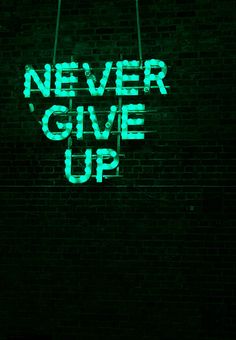 a neon sign that says never give up on a brick wall in the dark,