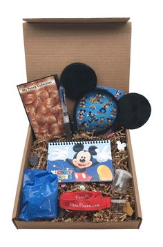 an open box containing mickey mouse and other items