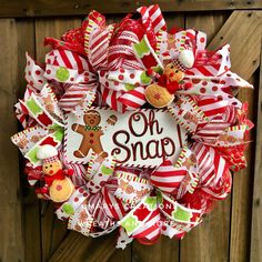 a red and white christmas wreath with gingerbreads, teddy bears and other holiday decorations