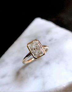 a close up of a ring on a marble surface