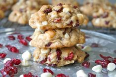 three cookies stacked on top of each other with cranberries and white chocolate chips