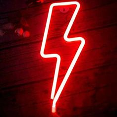 a red neon sign with a lightning bolt on it's side and the light is lit up