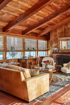 a living room filled with furniture and wooden walls