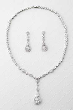 Add a touch of vintage flair to your special occasion ensemble with this radiant necklace of CZ jewels. This delicate necklace set is appropriate for weddings or any special occasion. It is 16 inches long with a locking clasp. the drop is 2 inches long. The earrings are post backs and 1 and 5/8 inches long. Grade AAA cubic zirconia, rhodium or rose gold plated, nickel and lead free. Chunky Silver Necklace, Bride Jewelry Set, Wedding Necklace Set, Diamond Jewelry Set, Sterling Silver Bead Bracelet, Bride Jewelry, Silver Bead Bracelet, Wedding Accessories Jewelry, Necklace Diamond