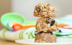 three oatmeal cookies stacked on top of each other in front of colorful plates