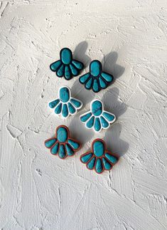 three blue and white decorated cookies sitting on top of a table next to each other