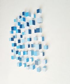 blue cubes are arranged in the shape of a rectangle on a white surface