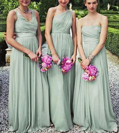 three bridesmaids in green dresses holding bouquets