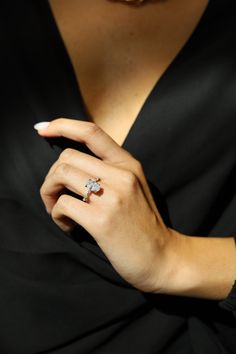 a woman wearing a diamond ring on her finger