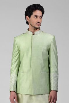 Sage green bandhgala jacket crafted in pure matka silk with embroidery details. Paired with a kurta and pant.
Components: 3
Pattern: Embroidered
Type Of Work: Thread
Neckline: Band collar
Sleeve Type: Long
Fabric: Silk
Color: Green
Other Details: 
Attached lining
Length:
Bandhgala: 29 inches and Sleeves: 25.5 inches
Kurta: 40 inches and Sleeves: 25 inches
Pant: 40 inches
Occasion: Mehendi and Puja - Aza Fashions Pista Green Bandhgala With Chikankari Embroidery, Designer Long Sleeve Pista Green Bandhgala, Pista Green Long Sleeve Designer Bandhgala, Pista Green Long Sleeve Bandhgala For Transitional Season, Pista Green Long Sleeve Bandhgala For Festive Occasions, Pista Green Long Sleeve Bandhgala For Festive, Festive Pista Green Long Sleeve Bandhgala, Festive Long Sleeve Pista Green Bandhgala, Formal Raw Silk Nehru Jacket With Naqshi