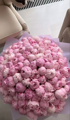 a bouquet of pink flowers sitting on top of a table