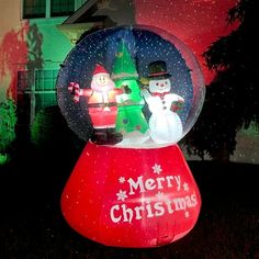 an inflatable snow globe with two snowmen inside and christmas decorations on top