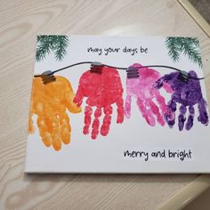 a card with handprints on it that says merry and bright hanging from a string