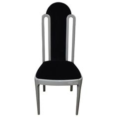 a black and silver chair with a white frame on the back side, against a white background