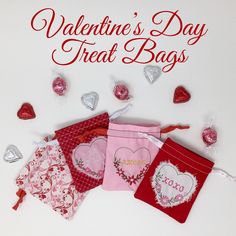 valentine's day treat bags with hearts and candy on the bottom, surrounded by heart - shaped candies