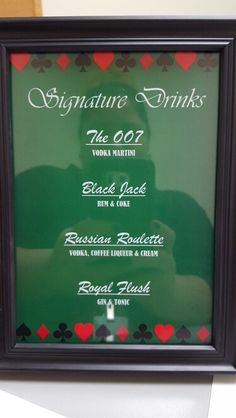 a black frame with red and green hearts on the bottom is holding a sign that says signature drinks