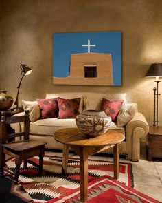 a living room filled with furniture and a cross on the wall