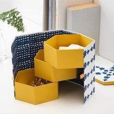 an open box sitting on top of a table next to a vase and other items