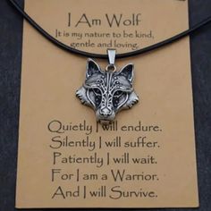 a necklace with a wolf head on it and an i am wolf quote in the middle