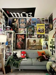 a living room filled with furniture and lots of posters on the wall above it's head