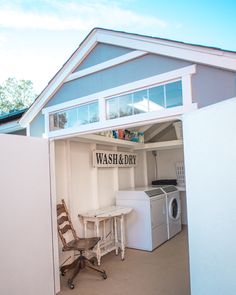 an open garage door shows the inside of a house with laundry and washing machines in it