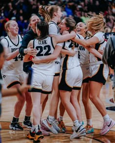 a group of women's basketball players huddle together