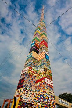 a very tall building made out of many different colored books on it's sides