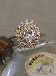 a diamond ring sitting on top of a bottle