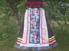 Native American Fire Colors Ribbon Skirt Goddess Size for Us Juicy Voluptuous Skins | Inlay Design Front Panel Native Ribbon Skirt      Black Cotton/Polyester Ribbon Skirt, embellished with: - Inlay Design Front Panel - Red, Orange, Yellow, and Grey Satin Ribbons - Dark Grey Ruffle Trim - 2" Elastic Waistband is Adjustable will "Cut to Size" (best fits waist plus sizes 2X, 3X, 4X, 5X or 6X)*  - Skirt without Elastic Waistband Measures: 48 inches wide - Skirt Length: 36 inches - No Pockets - Unlined * Measure the waist circumference and specify in "inches" the size you would like the 2" waistband cut to. Please double-check body measurements with outfit sizes before placing your order to get the best fit.  To measure your waist circumference, place a tape measure around your body at the top Ribbon Skirt Outfit, Native Ribbon Skirt, Senior Pants, Indigenous Artwork, Native American Dress, Ribbon Skirt, Wide Skirt, American Dress, Inlay Design