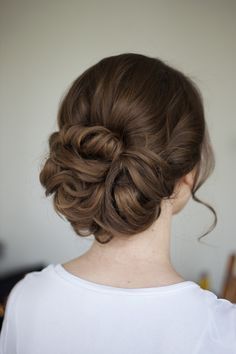 a woman with her hair in a low bun