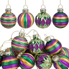 a bunch of christmas ornaments hanging from strings